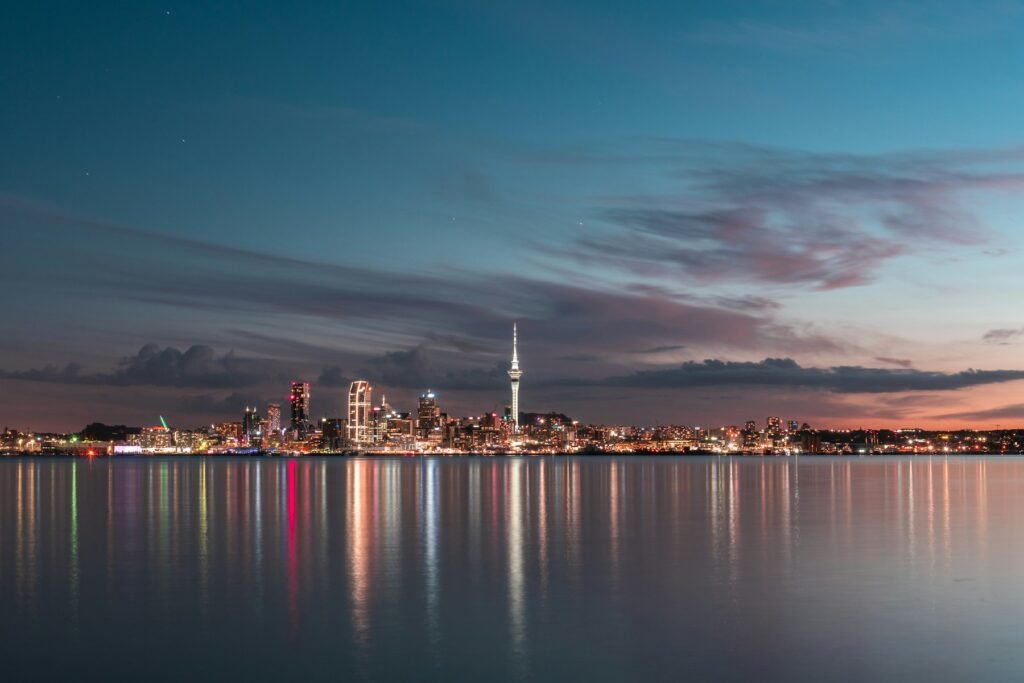 Auckland city skyline and Sky Tower across the Waitematā Harbour at dusk