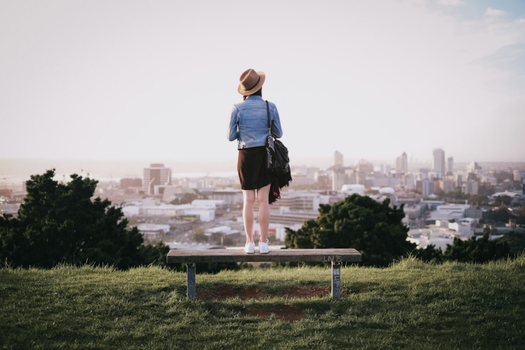 Person looking out over central Auckland from a grassy hilltop